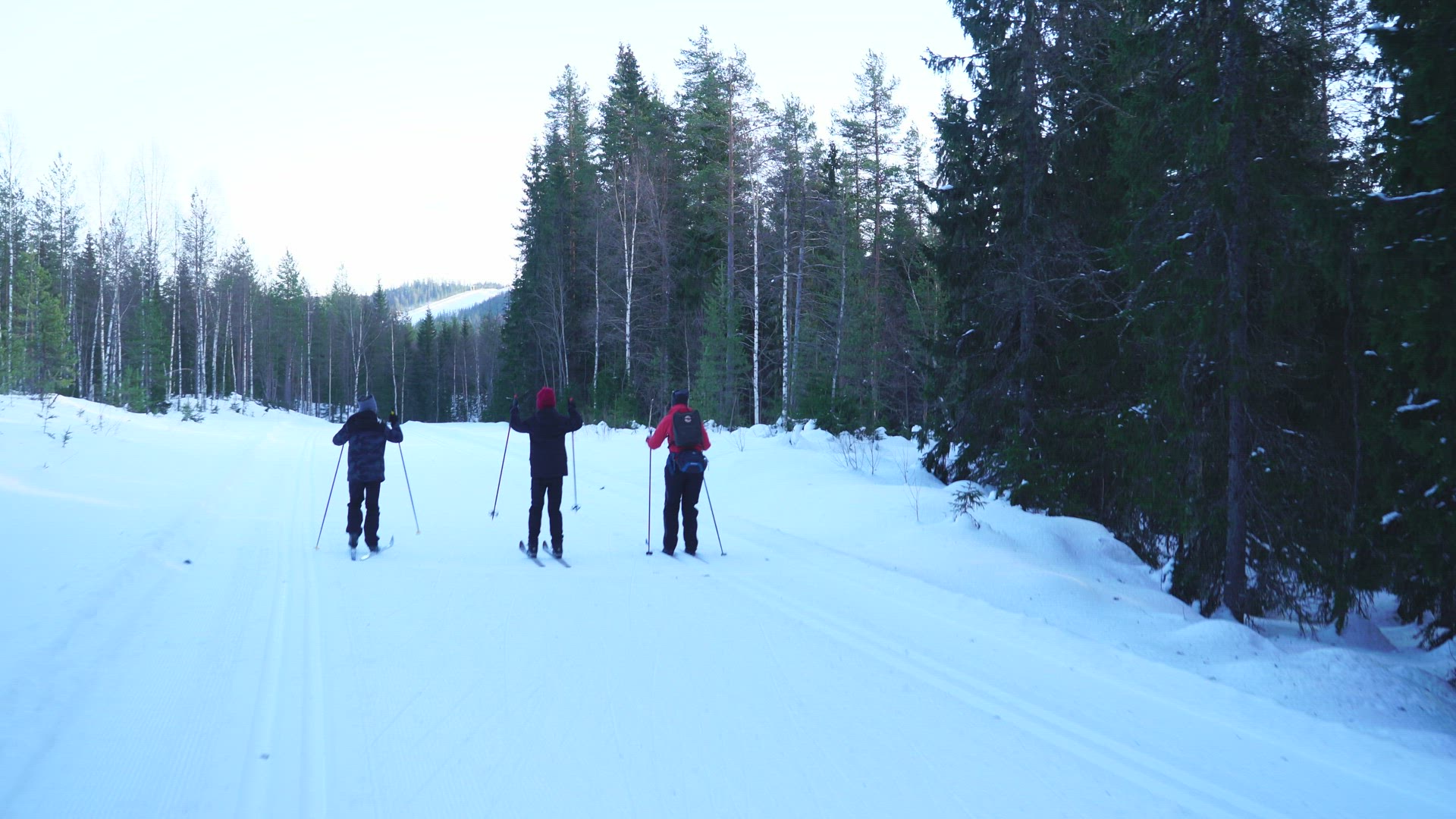 pov skiers vies - woman and two boys skiing in ski tracks 