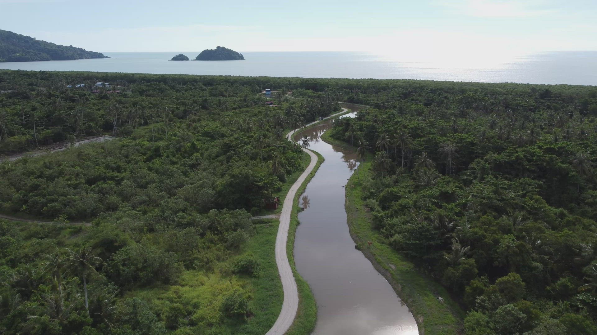 Aerial view fly over winding river toward sea.