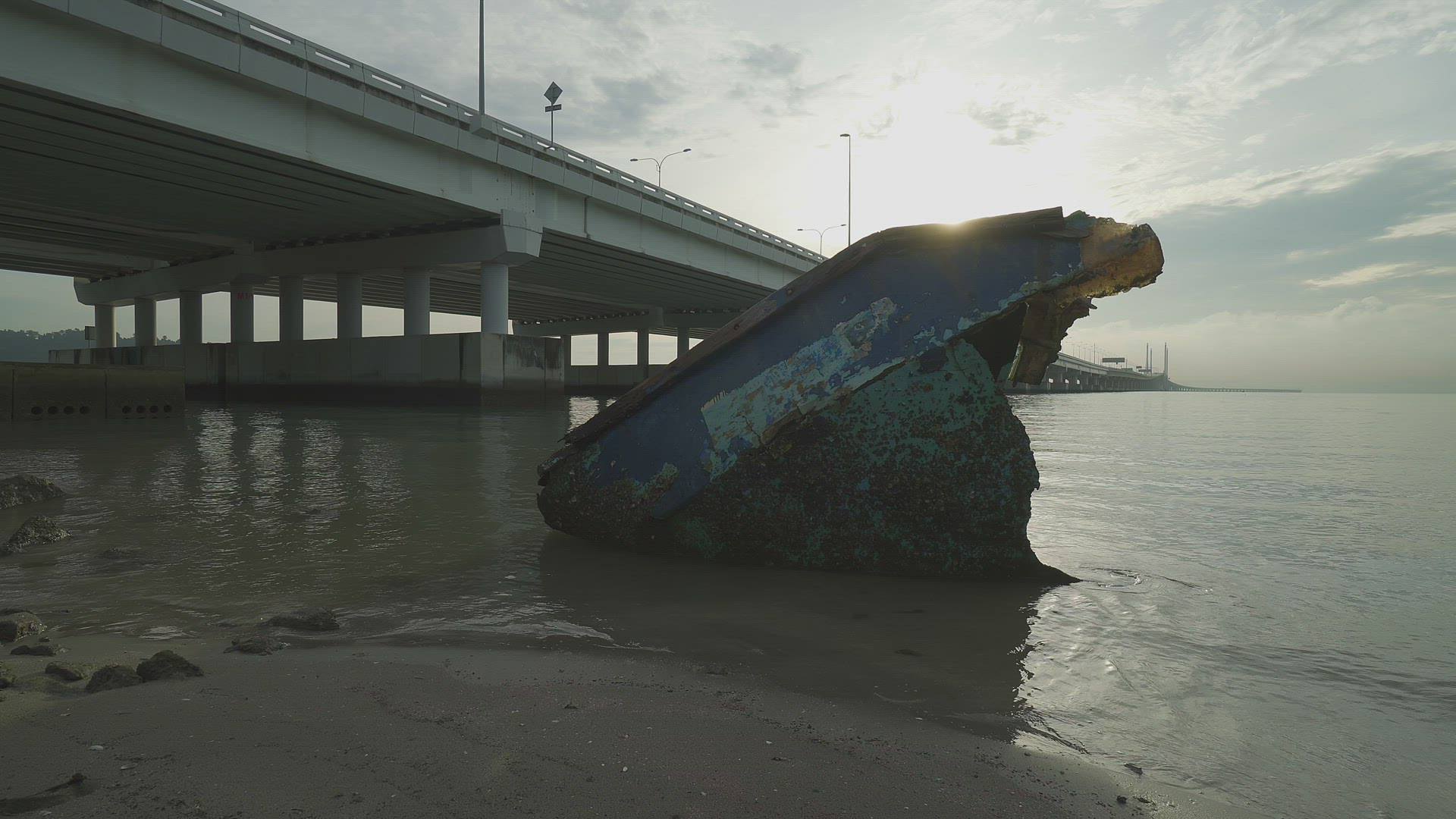 Sunken ship at sea coastal near bridge