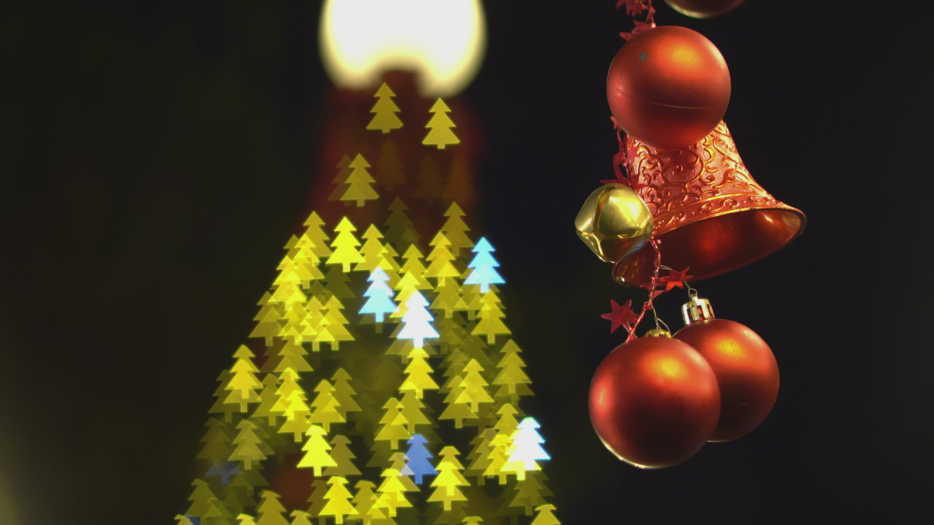 Ornament christmas hand with bokeh christmas tree.
