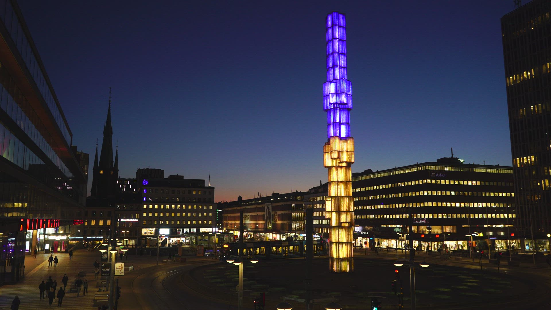 Sergels Torg in Stockholm - crystal sculpture lit in ukrainian colours - tramcar driving