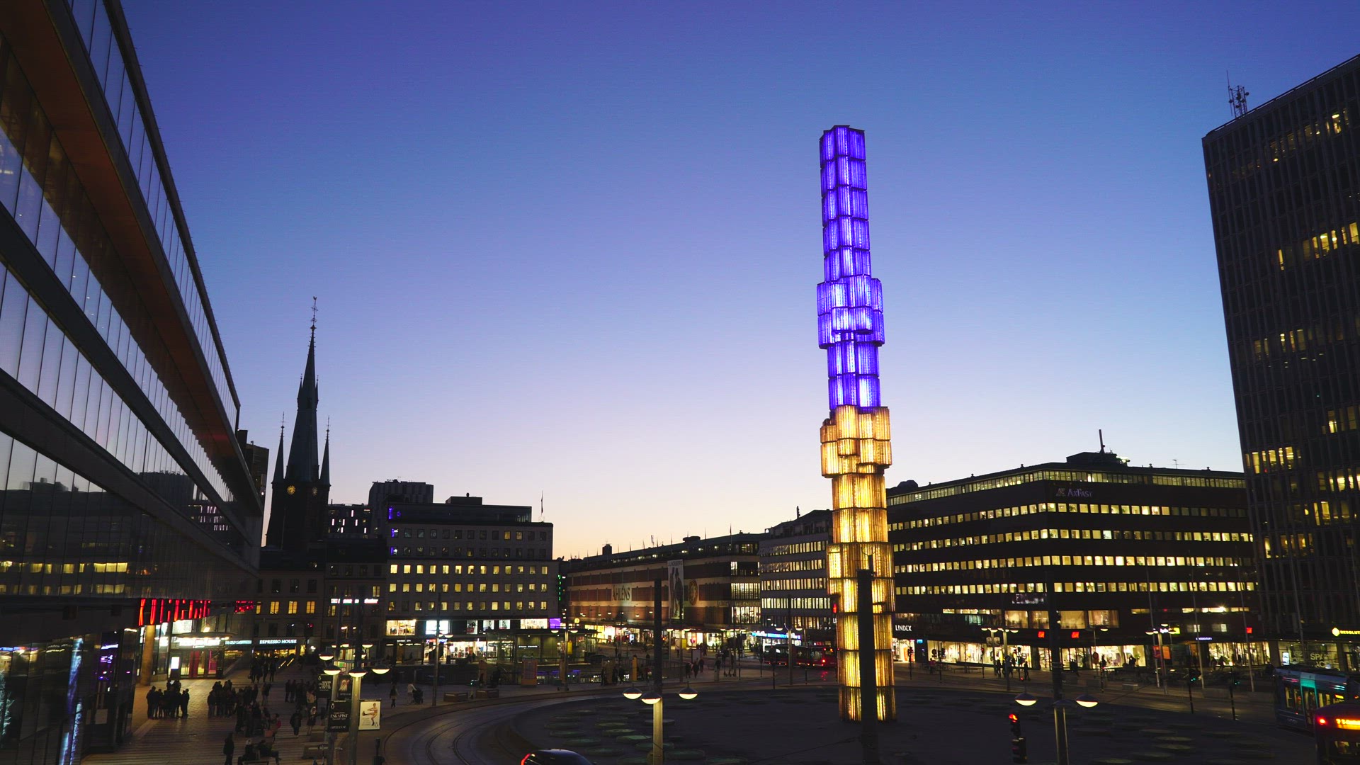Sergels Torg in Stockholm - crystal sculpture lit in ukrainian colours - tramcar driving