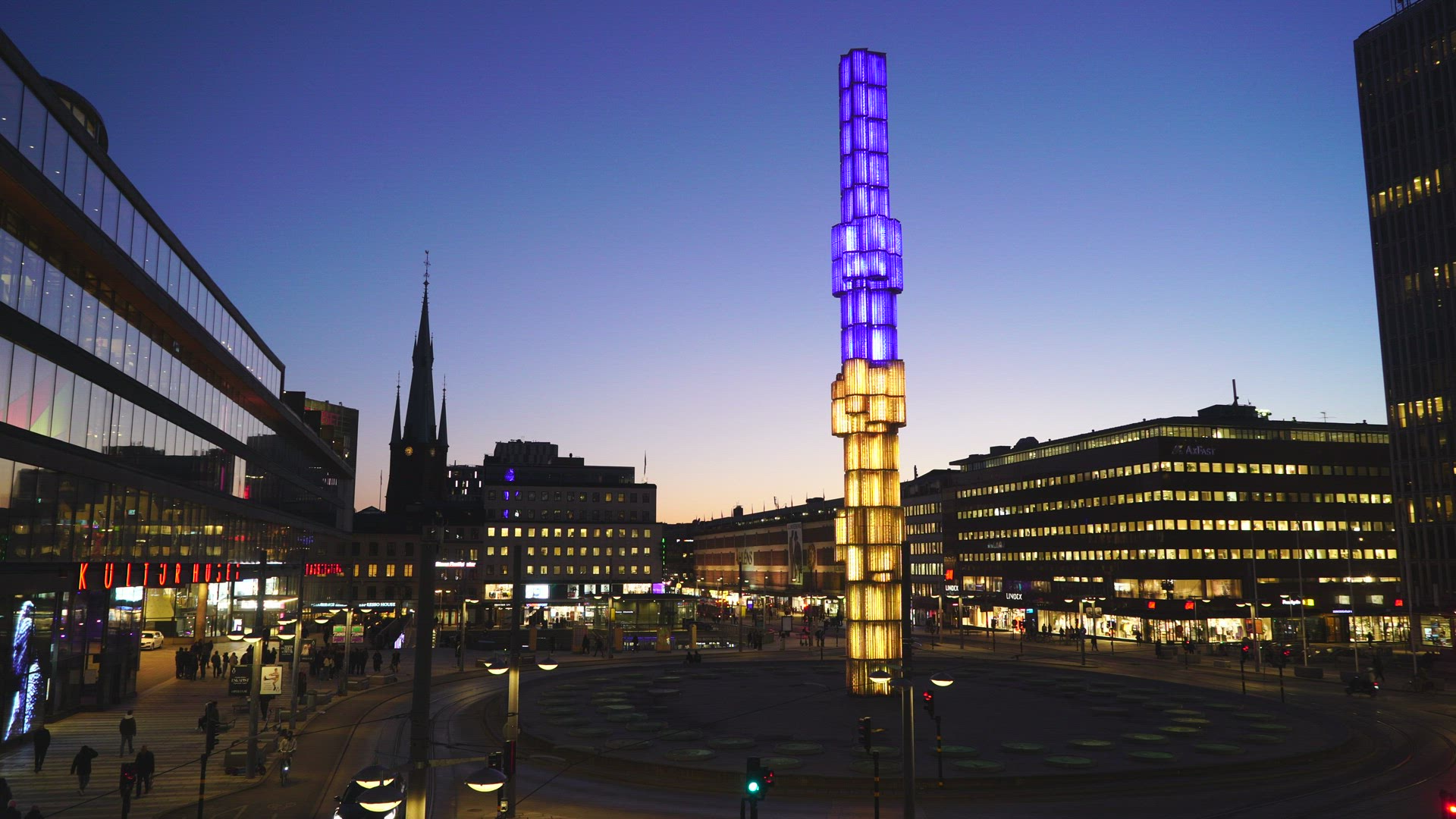 glass sculpture at Sergels Torg in Stockholm - lit in ukrainian colours - yellow and blue