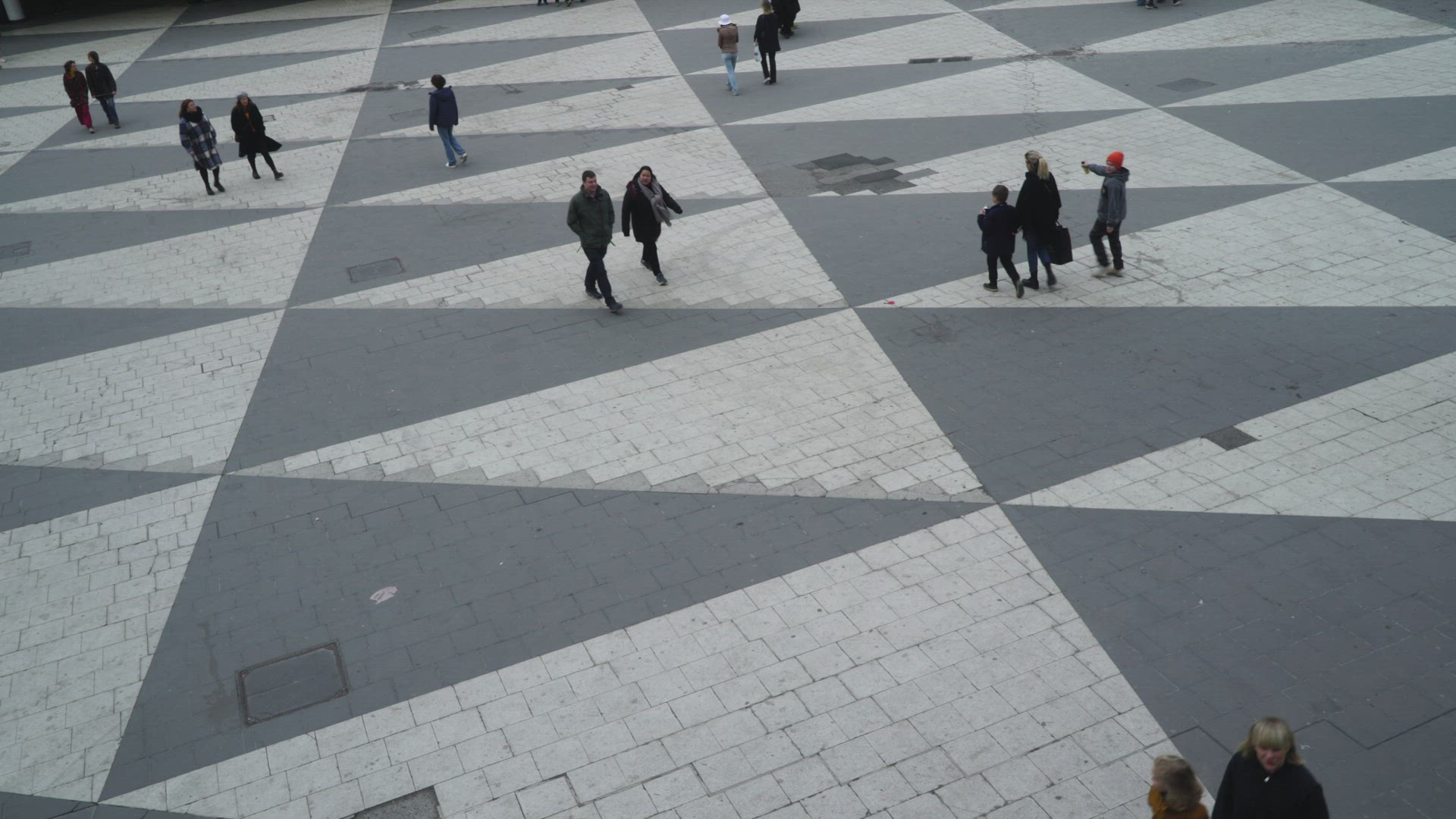 people walking - crossing Sergels Torg in Stockholm - boy chasing dove