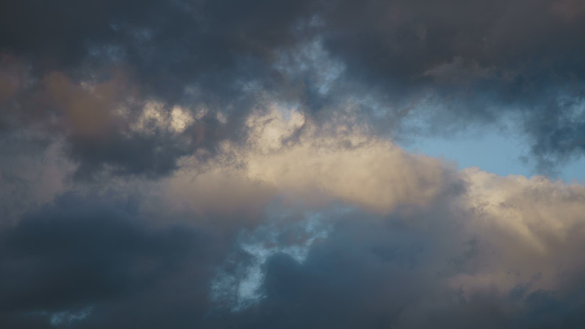 Clouds transform and change in a blue sky during a sunset