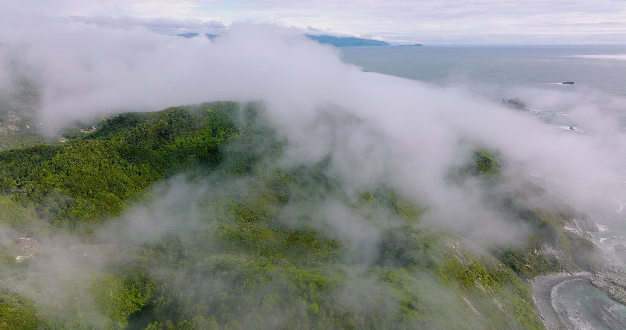 Drone Flying Over Clouds Revealing Scenic Chiloe Island Coastline