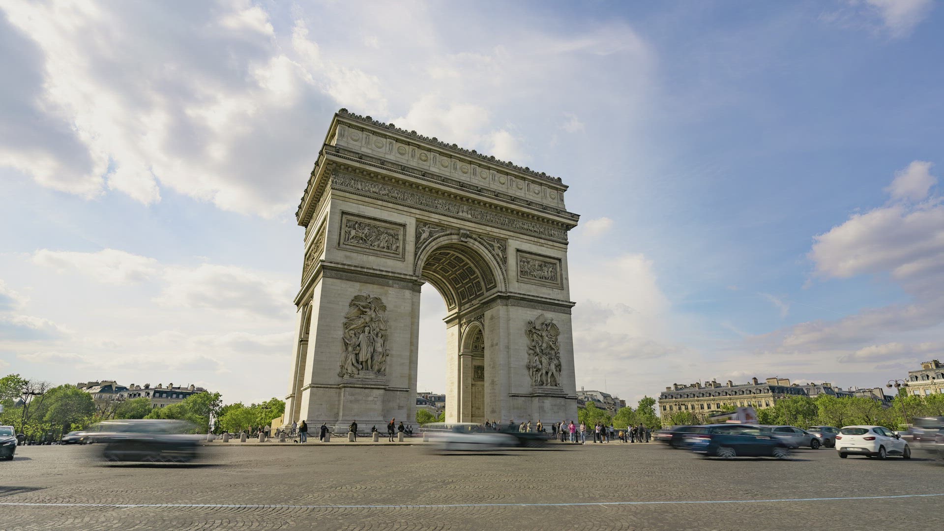 Paris, France, Timelapse - The Arc de Triomphe and the city traffic on the Champs-Elysees during a s