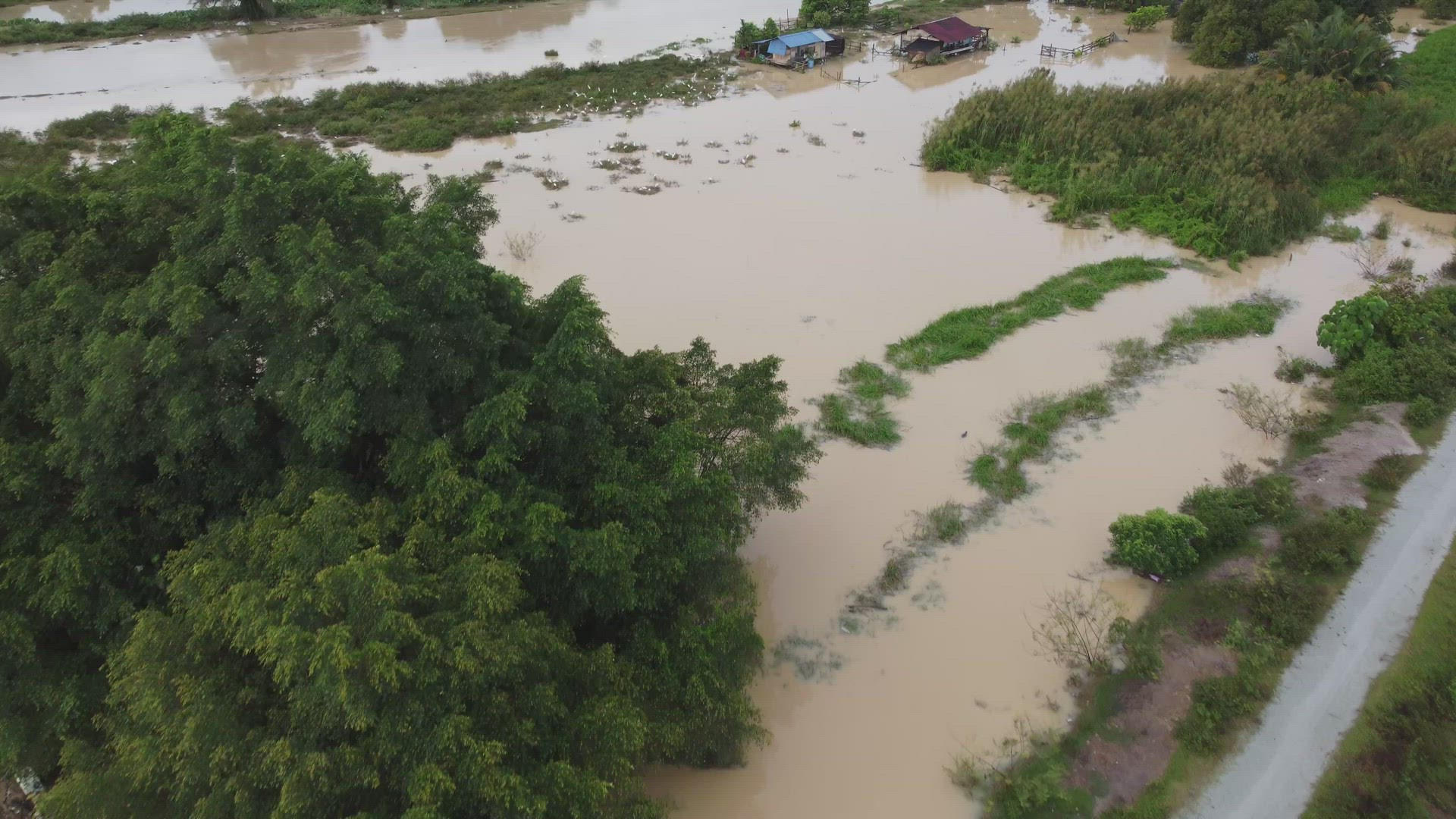 Aerial view flood near the Malays kampung house beside river