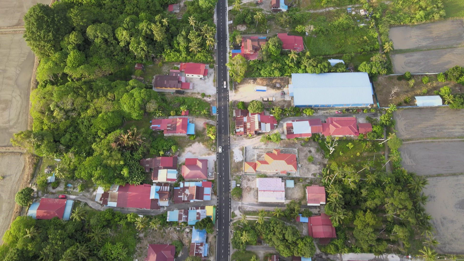 Aerial view look down sun shine at the road near Malays village