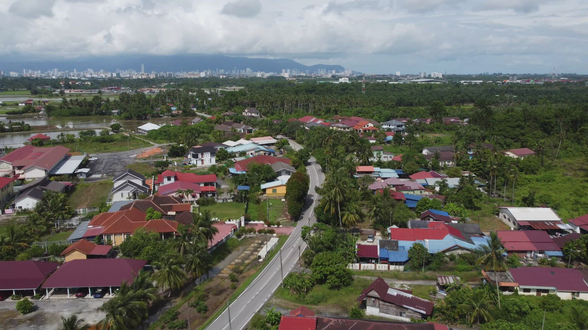 Aerial view follow the asphalt road at Malays kampung