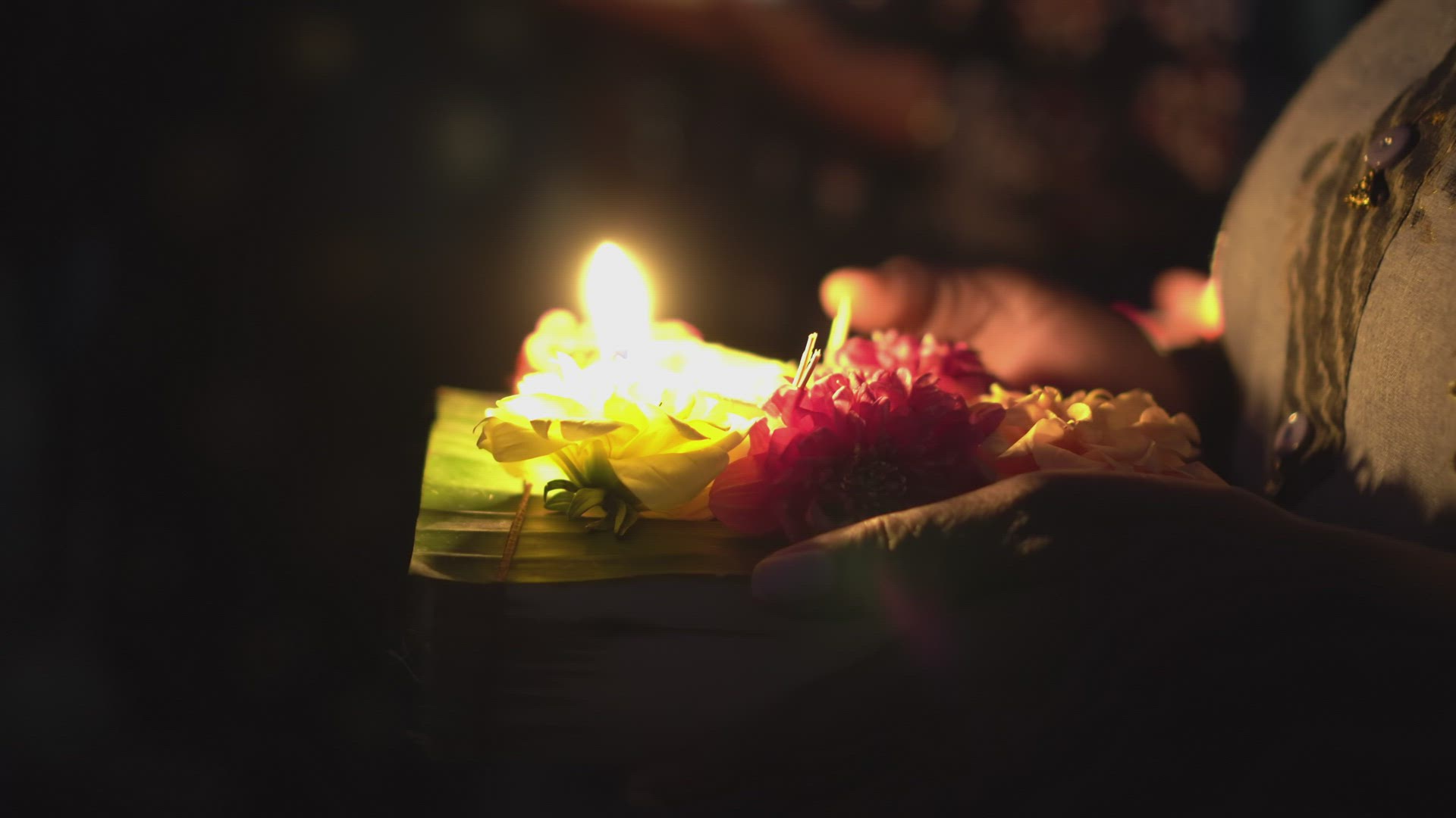 Indian girl hand hold the lamp of candle with flower