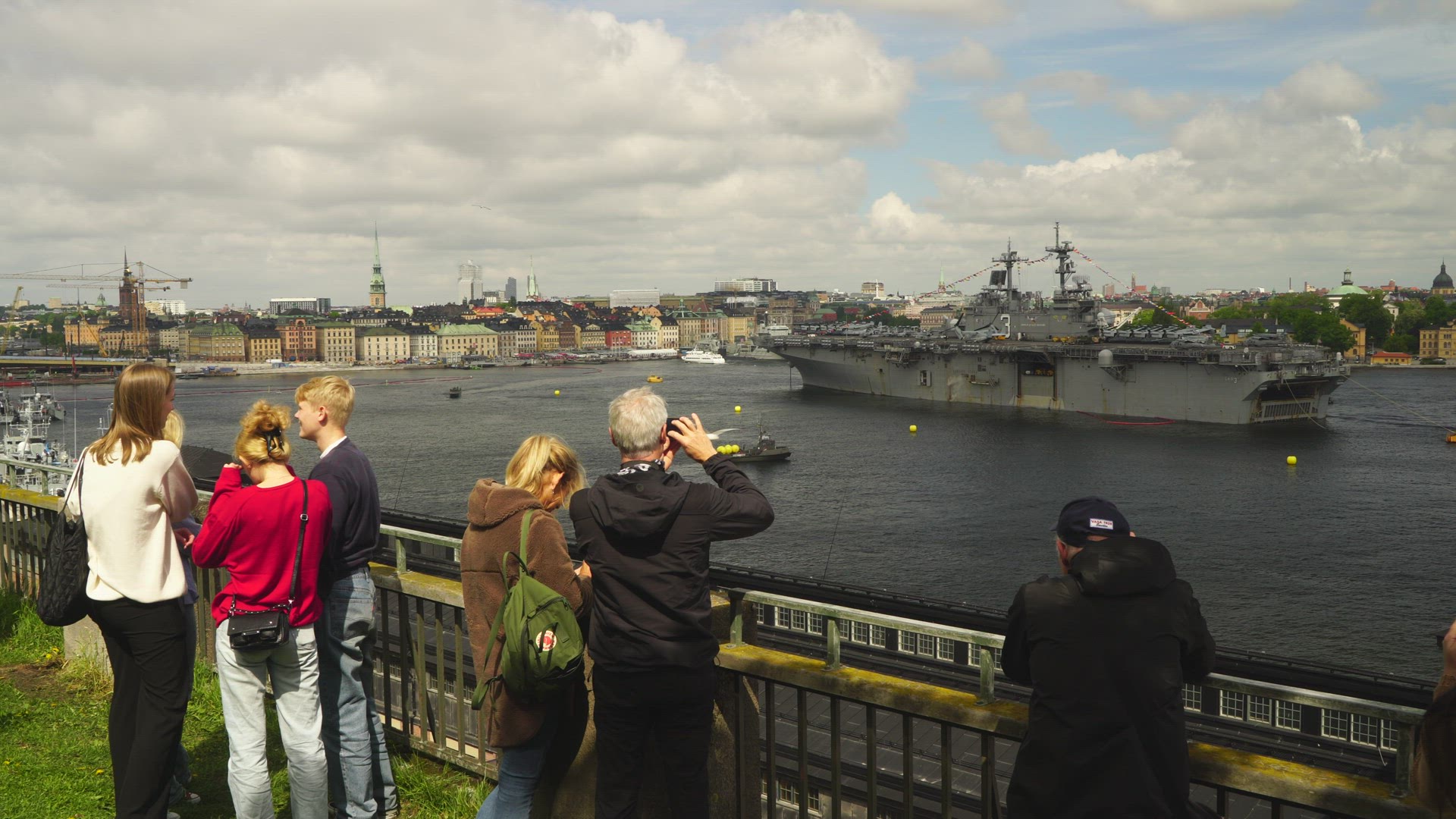 people watching and taking photos of USS Kearsarge in Stockholm