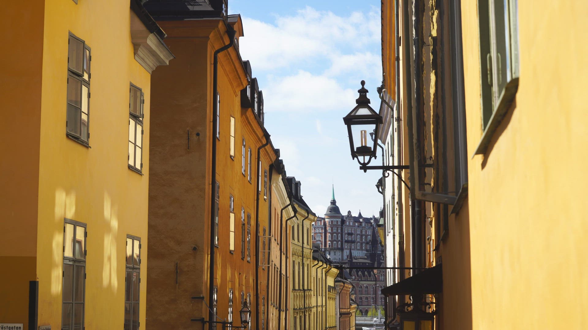 view facades of old houses on narrow street in Old Town in Stockholm