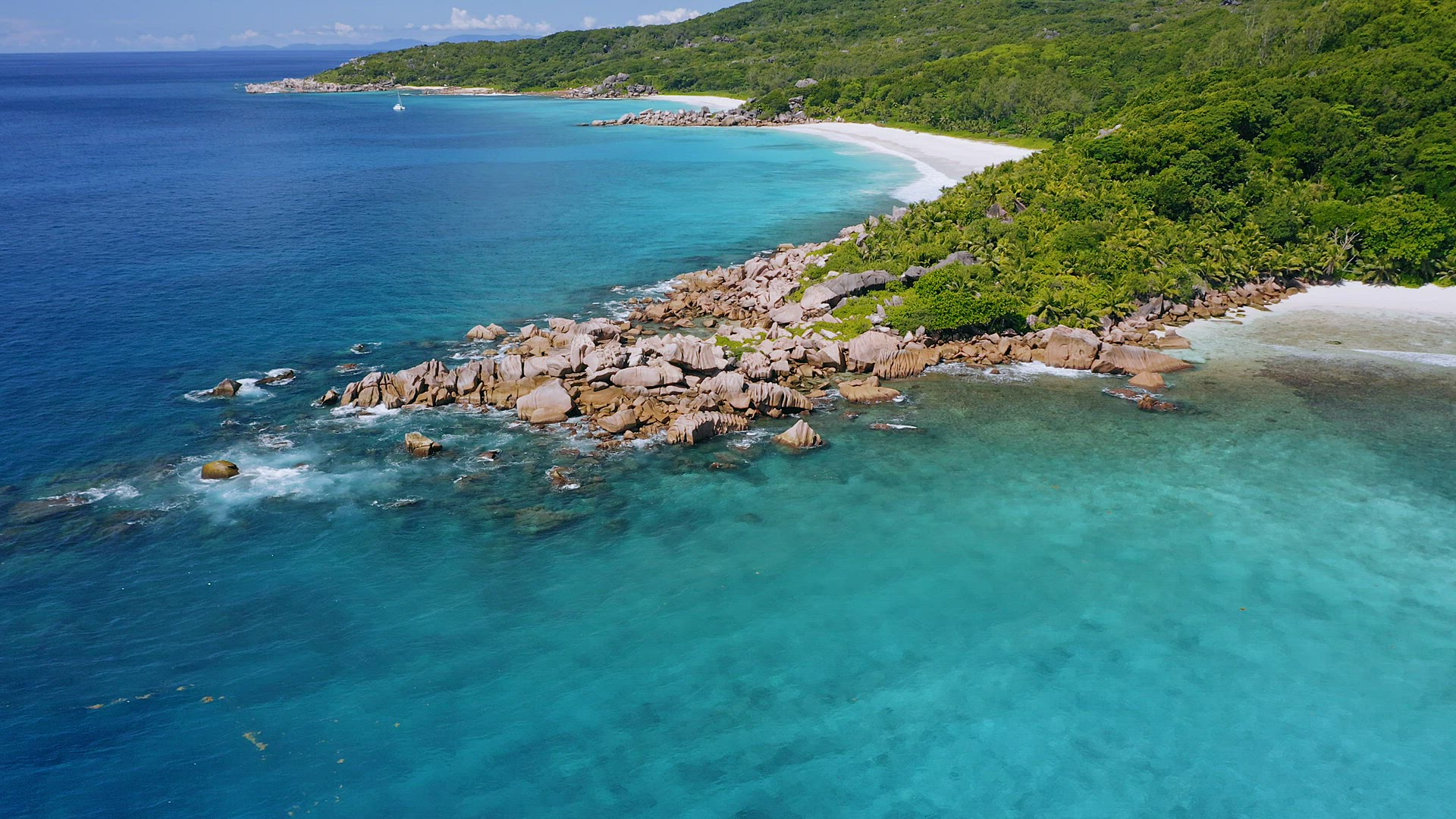 4K drone aerial side flight above azure crystal clear ocean water along picturesque coastline on tro