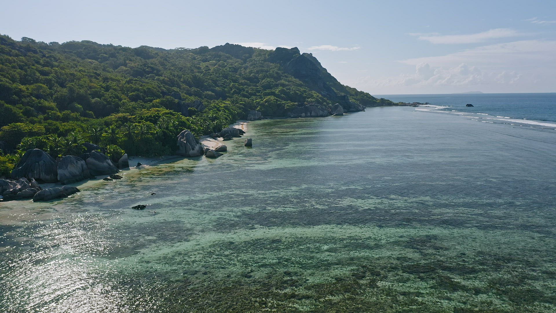 Aerial footage of tropical paradise beach Anse Source d'Argent. Shallow lagoon with beautiful algae 