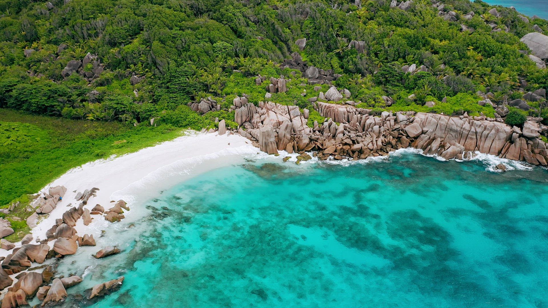 Aerial view of most beautiful tropical hidden beach with white sand and aquamarine bay water surroun
