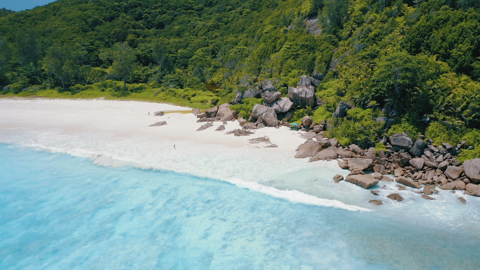 4K drone side flight above turquoise crystal clear ocean water and powerful surf on tropical paradis