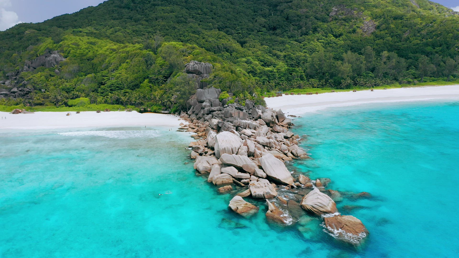 4K aerial drone side flight over turquoise crystal clear ocean water in front of tropical white sand