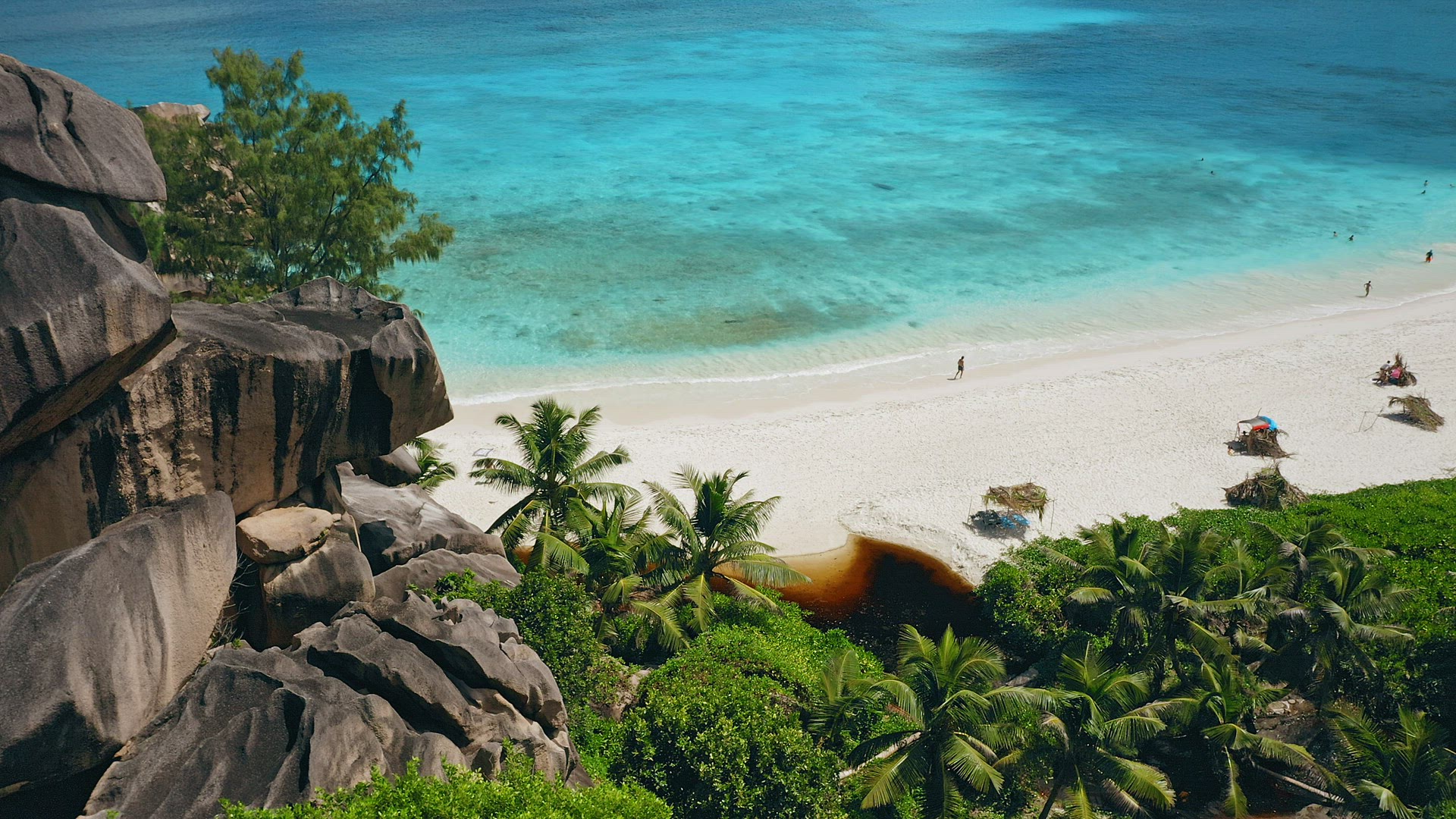 Aerial still footage of white sand Grand Anse beach. Crystal clear turquoise blue ocean lagoon. La D