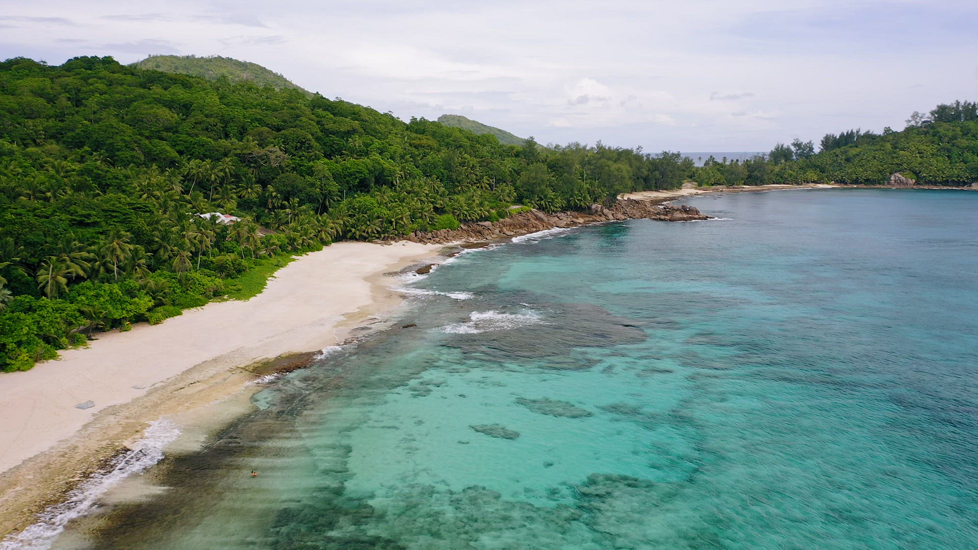 Aerial view of white sand paradise tropical beach Anse Bazarca at Mahe island, Seychelles. Summer va