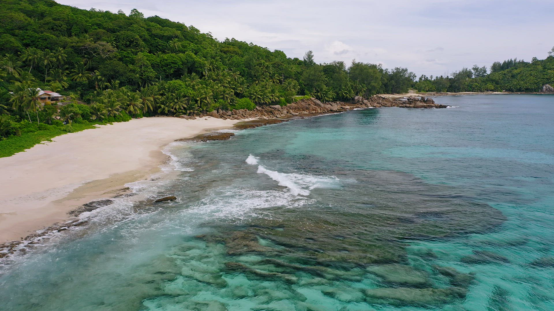 Aerial view of ocean waves at white sand paradise like tropical beach Anse Bazarca at Mahe island, S