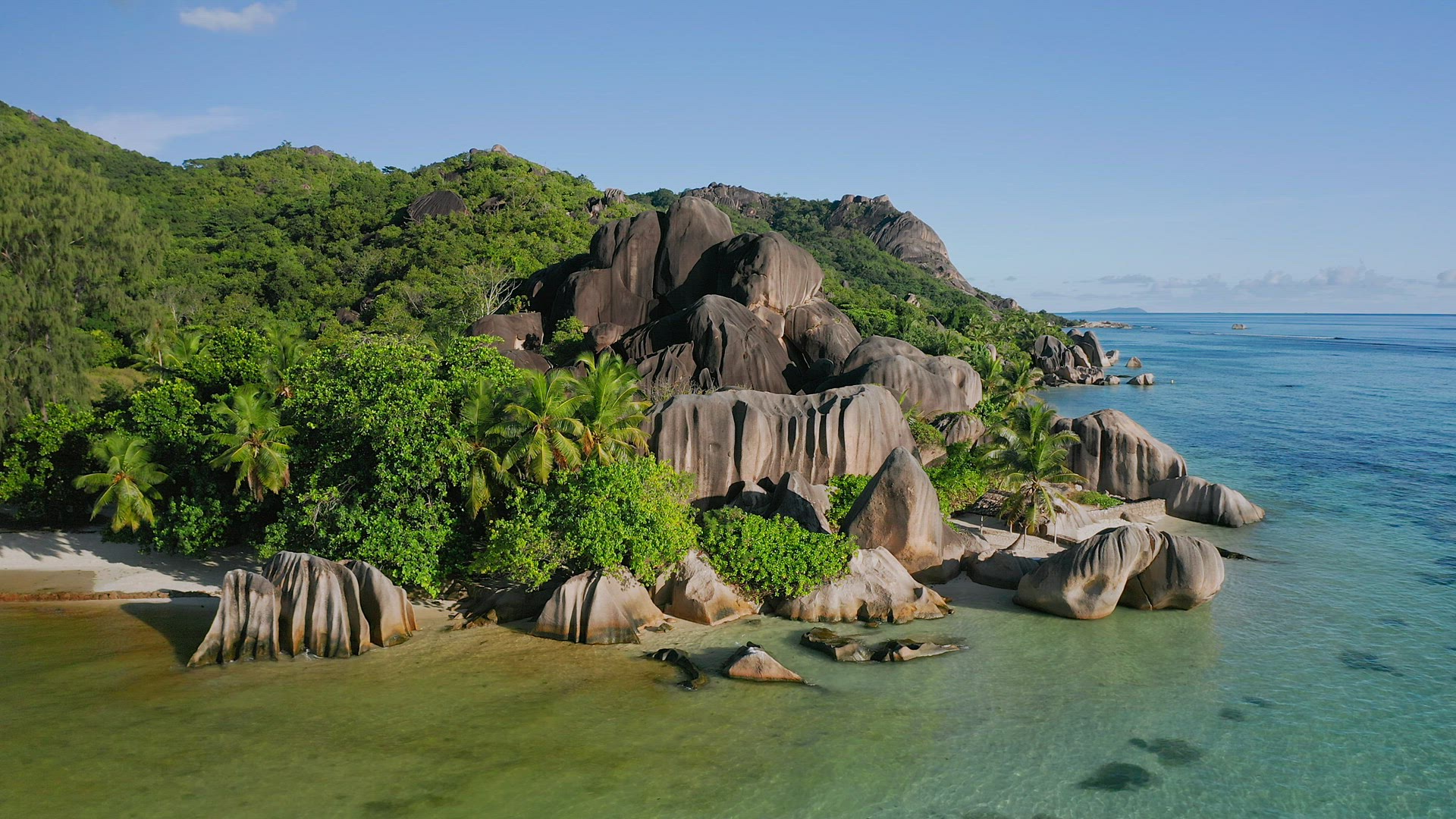 Aerial footage of famous granite boulders on Anse Source d'Argent tropical beach at sunny day bright