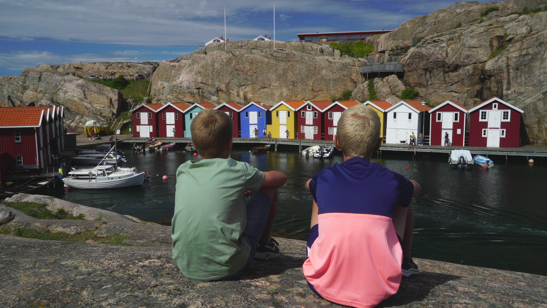 Boys watching colourful fishing huts in Smögen -  landmarks