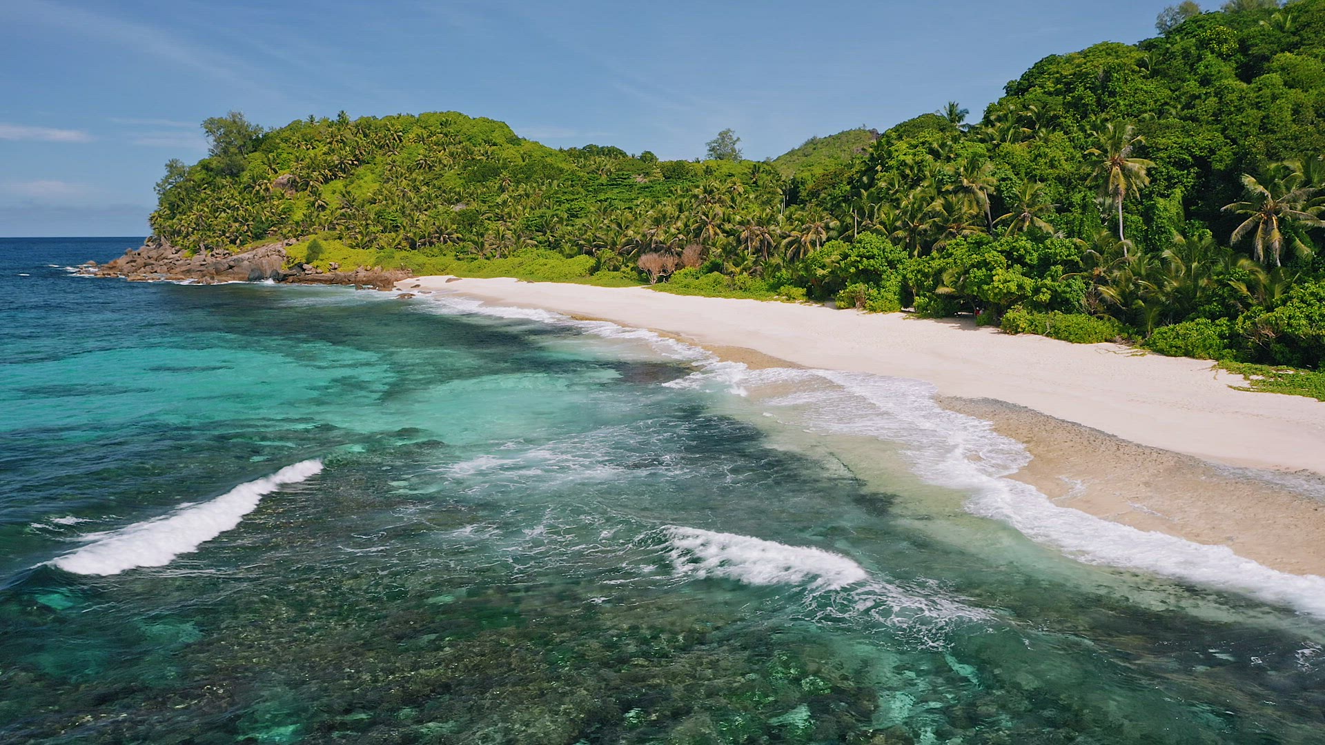 Mahe island, Seychelles. Aerial view of tropical beach, ocean rolling waves and white sand beach wit