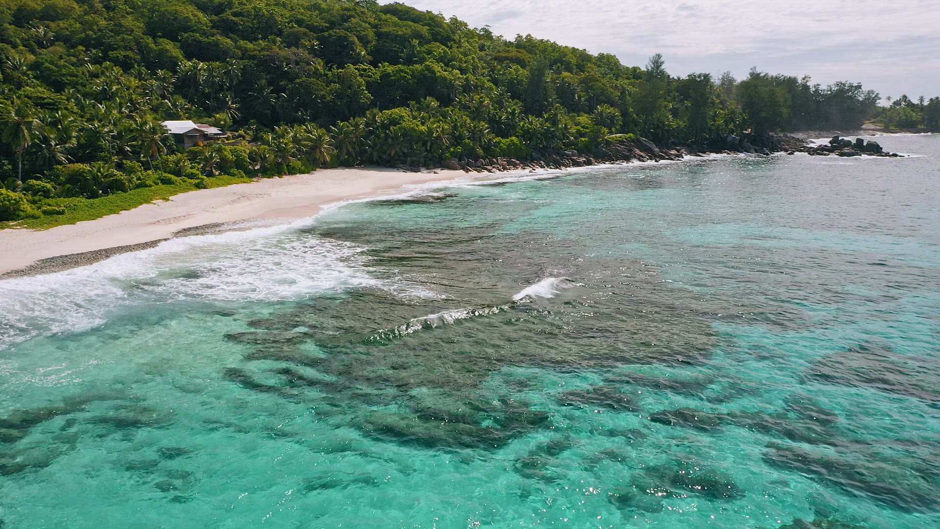 Aerial top view of white sand paradise tropical beach Anse Bazarca at Mahe island, Seychelles. Summe