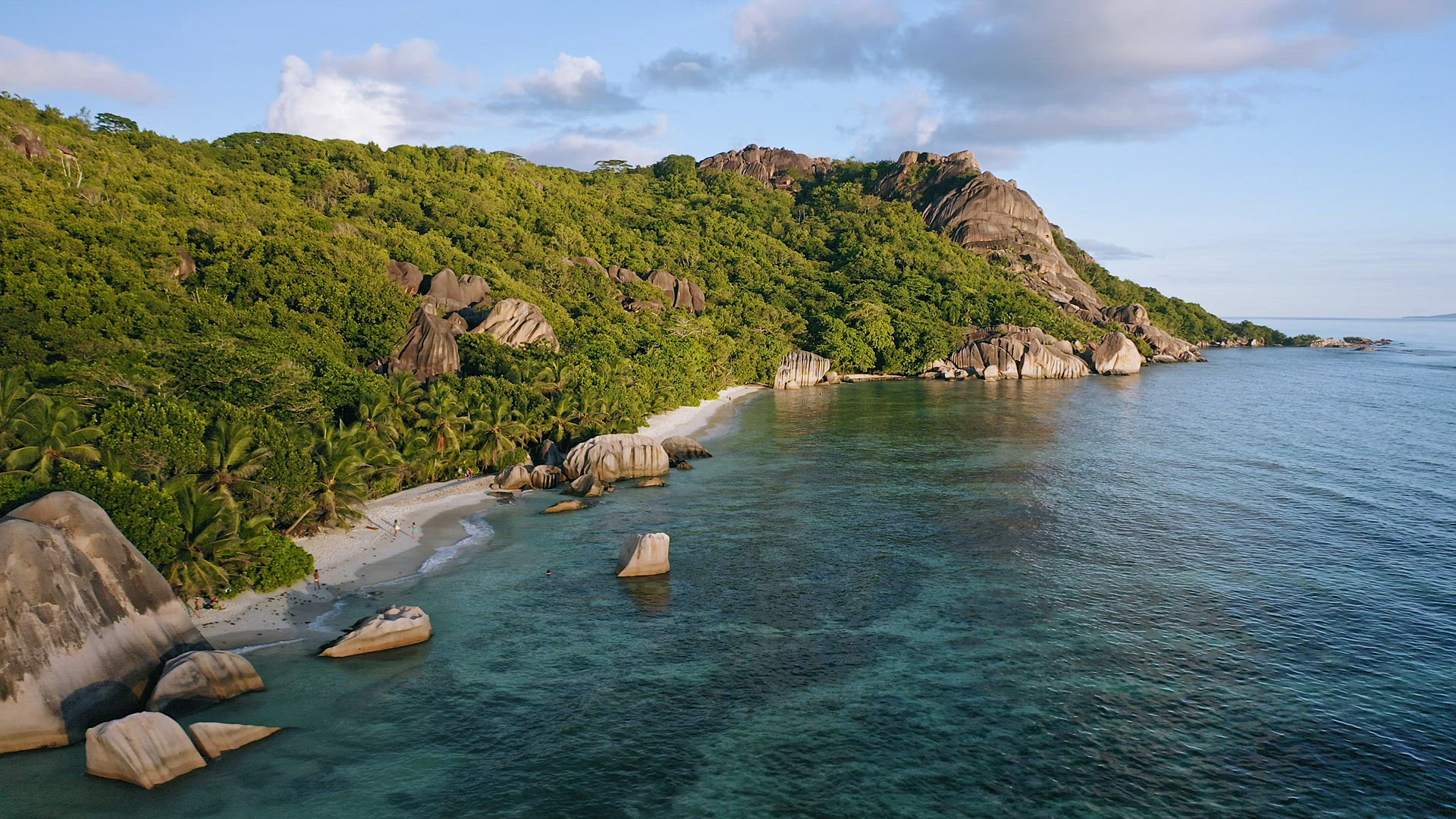 Aerial footage of famous tropical beach Anse Source d'Argent at sunset evening light. La Digue Islan