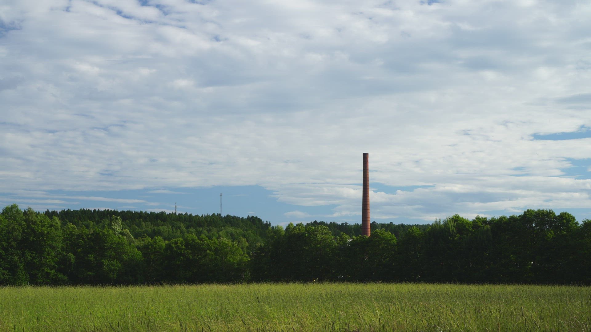 factory chimney - field in foreground
