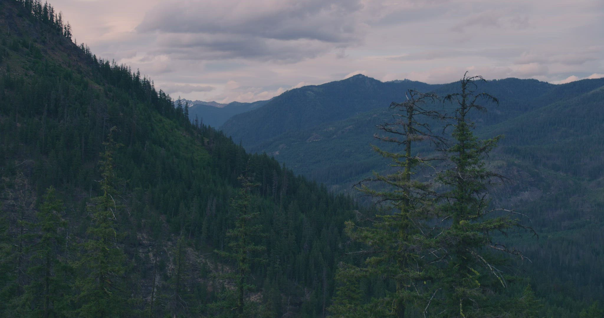 Wide static shot of mountains at twilight