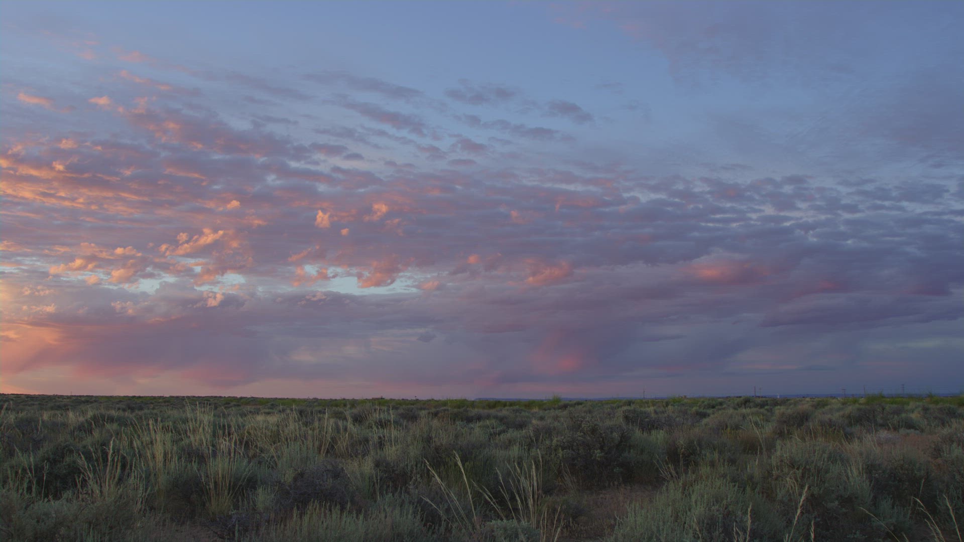 Slow pan across breathtaking Vernal Utah field and telephone poles at sunrise