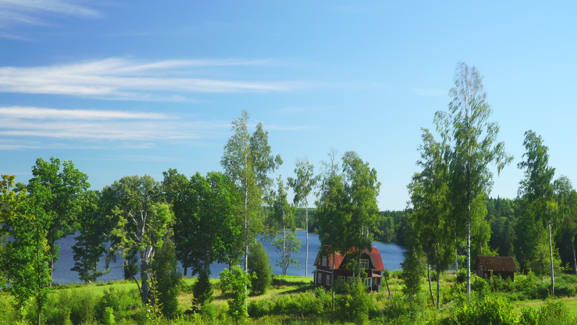 abandoned red house close to lake in swedish forest