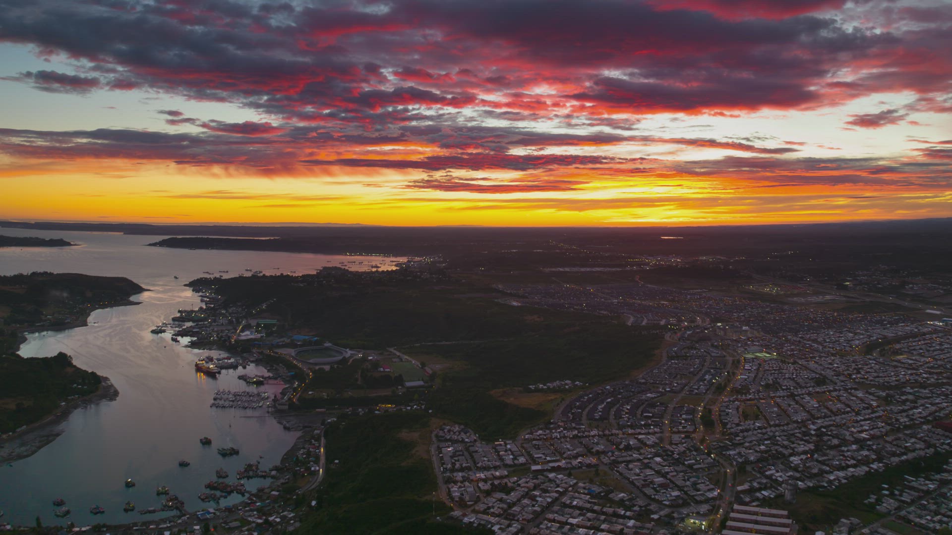 aerial time lapse of sunset, showing vehicular traffic of people