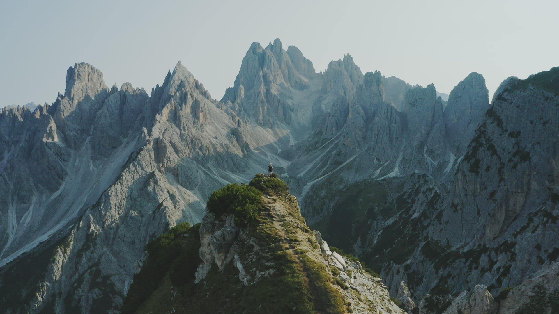 Dolomites, Italy. Aerial panoramic view of women hiker enjoying Auronzo di Cadore peaks of Cadini di