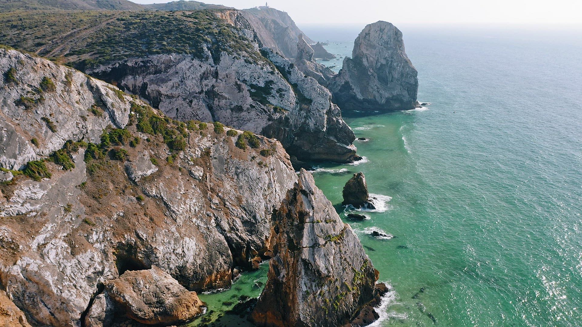 4K Aerial view of rocky cliff coastline near Praia da Ursa beach and Cabo da Roca located on Atlanti