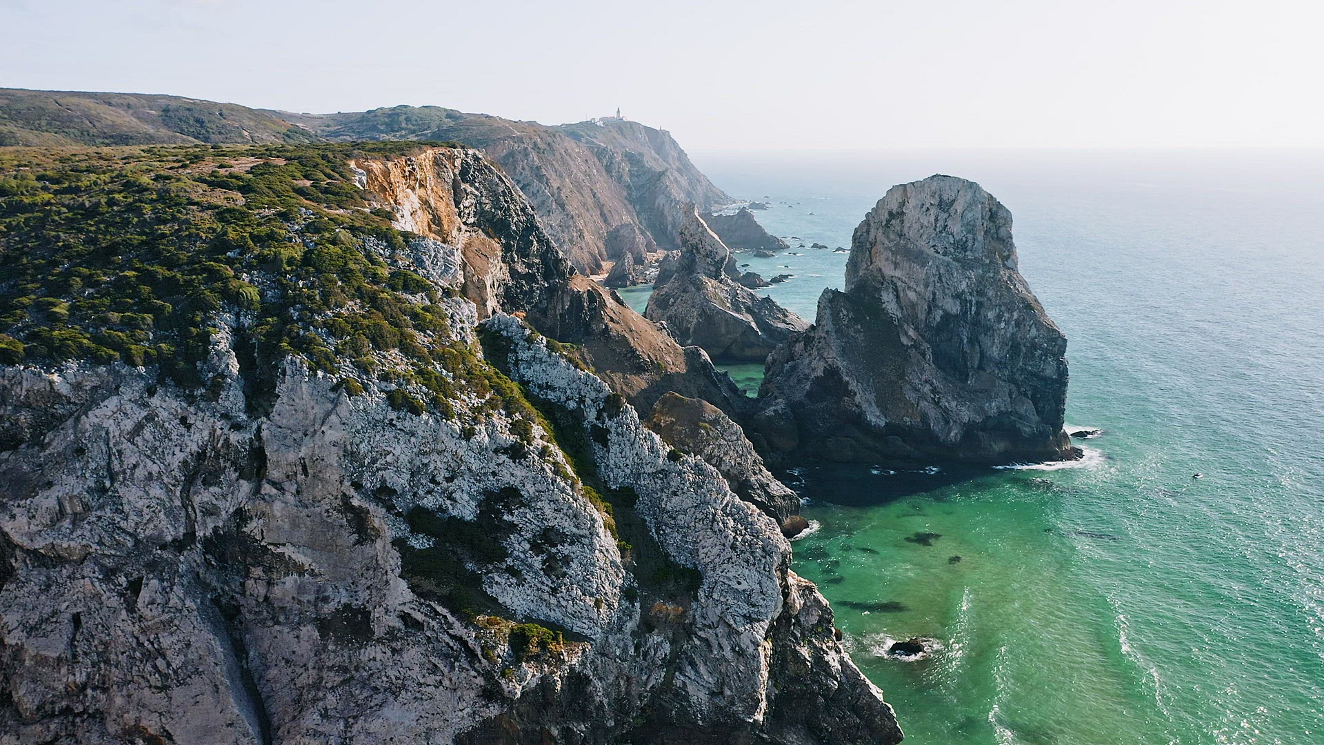 4K Aerial view of rocky cliff coastline near Praia da Ursa beach and Cabo da Roca located on Atlanti