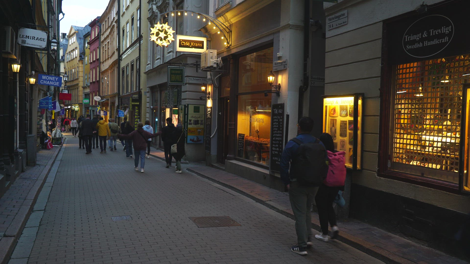 motorcycle messenger driving on narrow street in old town stockholm