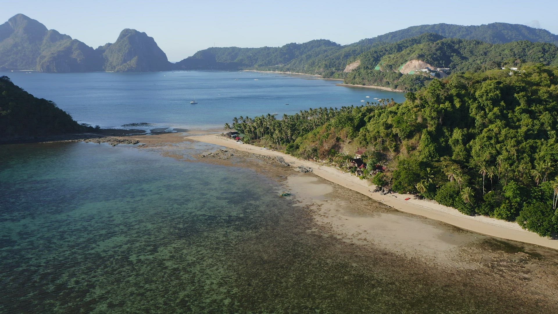 4k Aerial goes down footage of Cas Cabanas tropical beach, El Nido, Palawan, Philippines. Mountain r