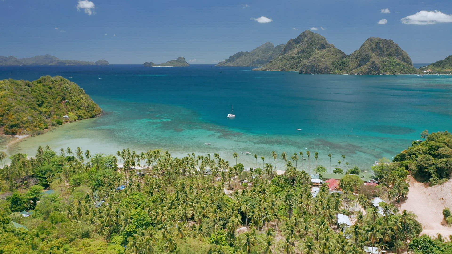 Aerial drone panoramic coastline view of Las Cabanas beach with sail boat in blue water, sandy beach