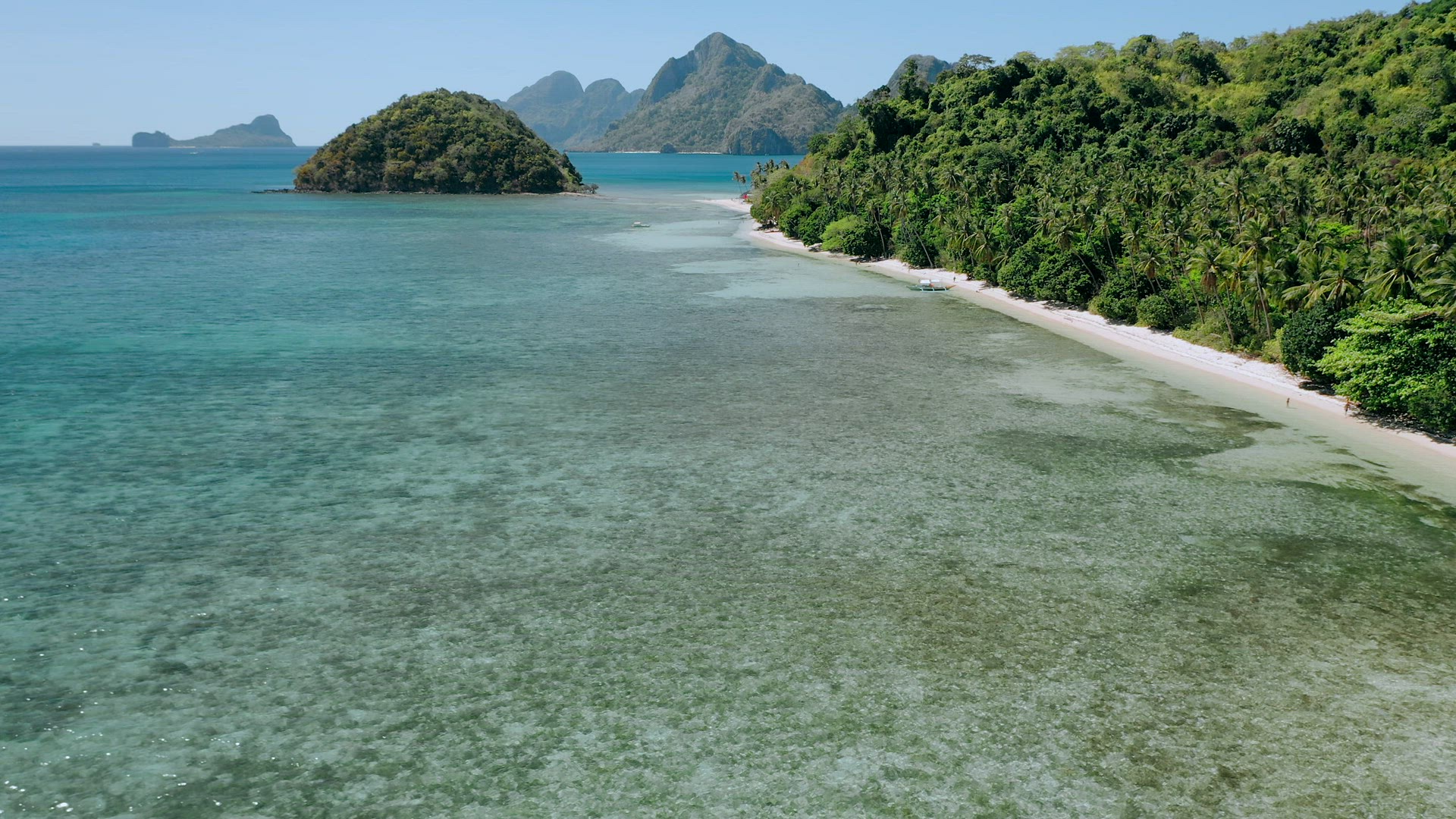 4k Aerial drone flying over shallow clear water along paradise tropical beach with coconut palms swi