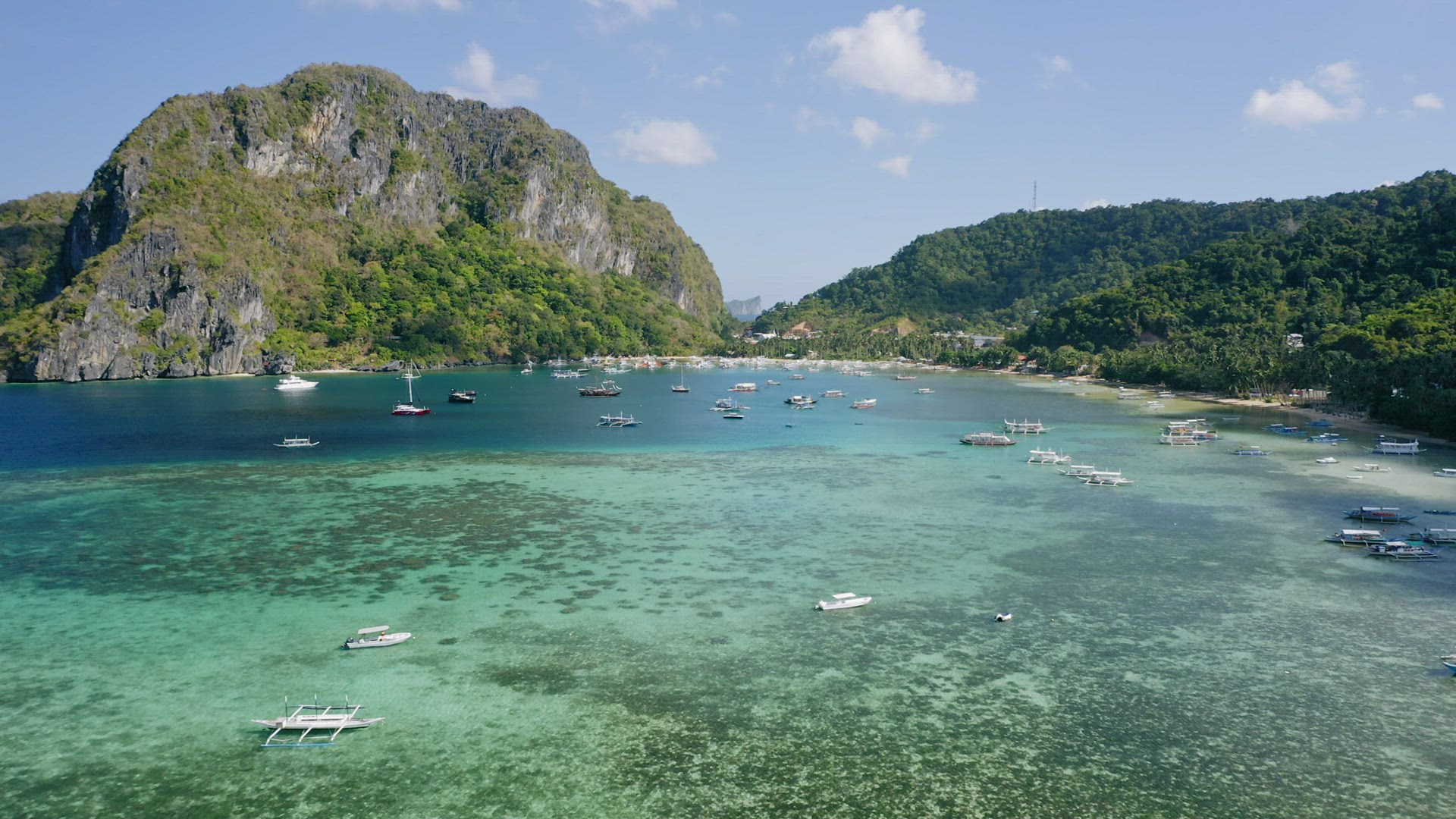 Corong Corong beach, El Nido, Palawan island, Philippines - 4K Aerial drone view of boats anchored i