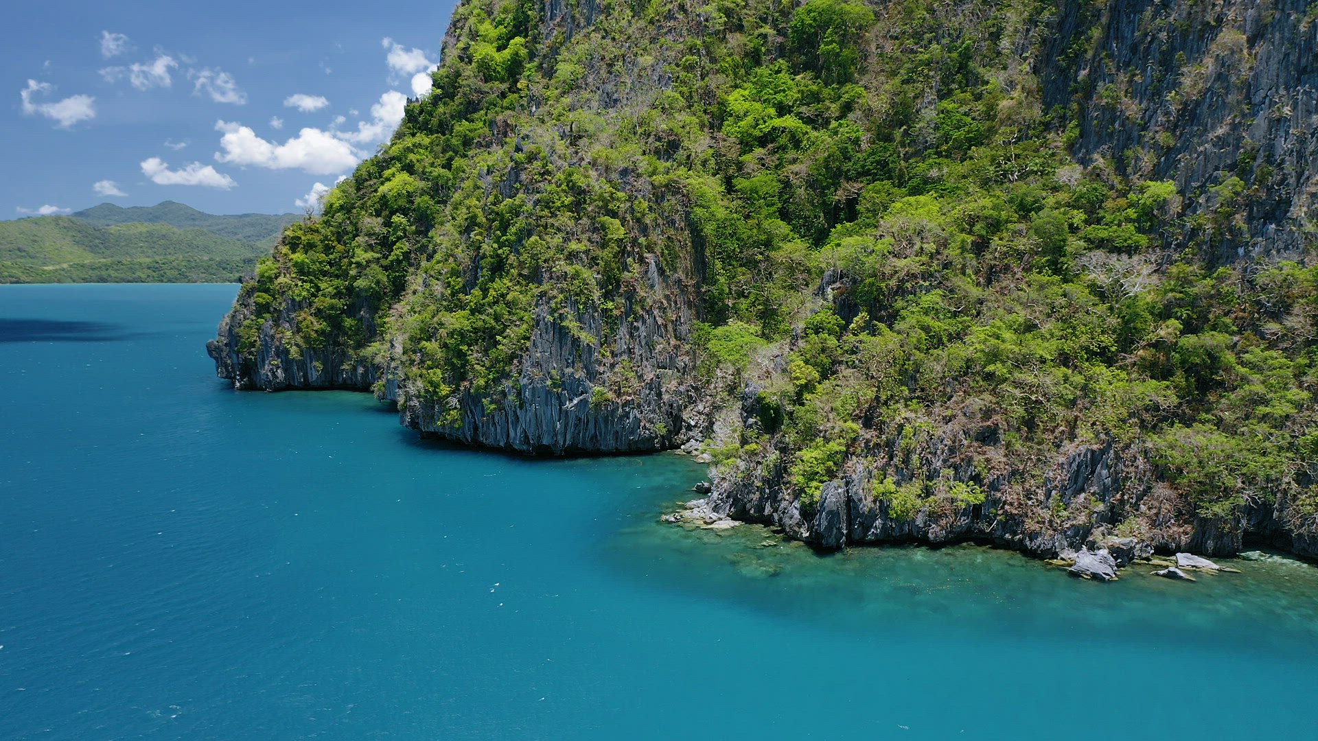 4k Aerial view of an impassable rocky cliffs island. El Nido, Palawan, Philippines. Unspoiled island