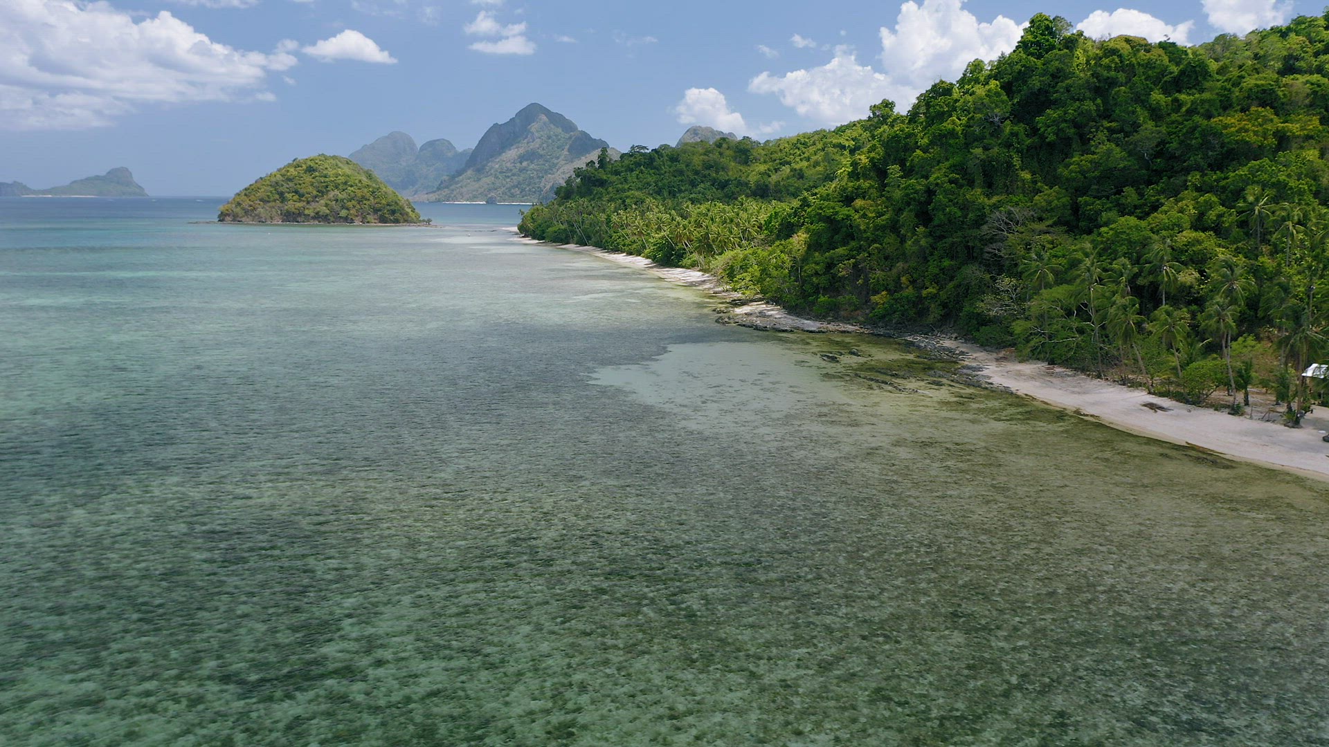 4k Aerial view of Cas Cabanas tropical beach, El Nido, Palawan, Philippines. Shallow lagoon during l