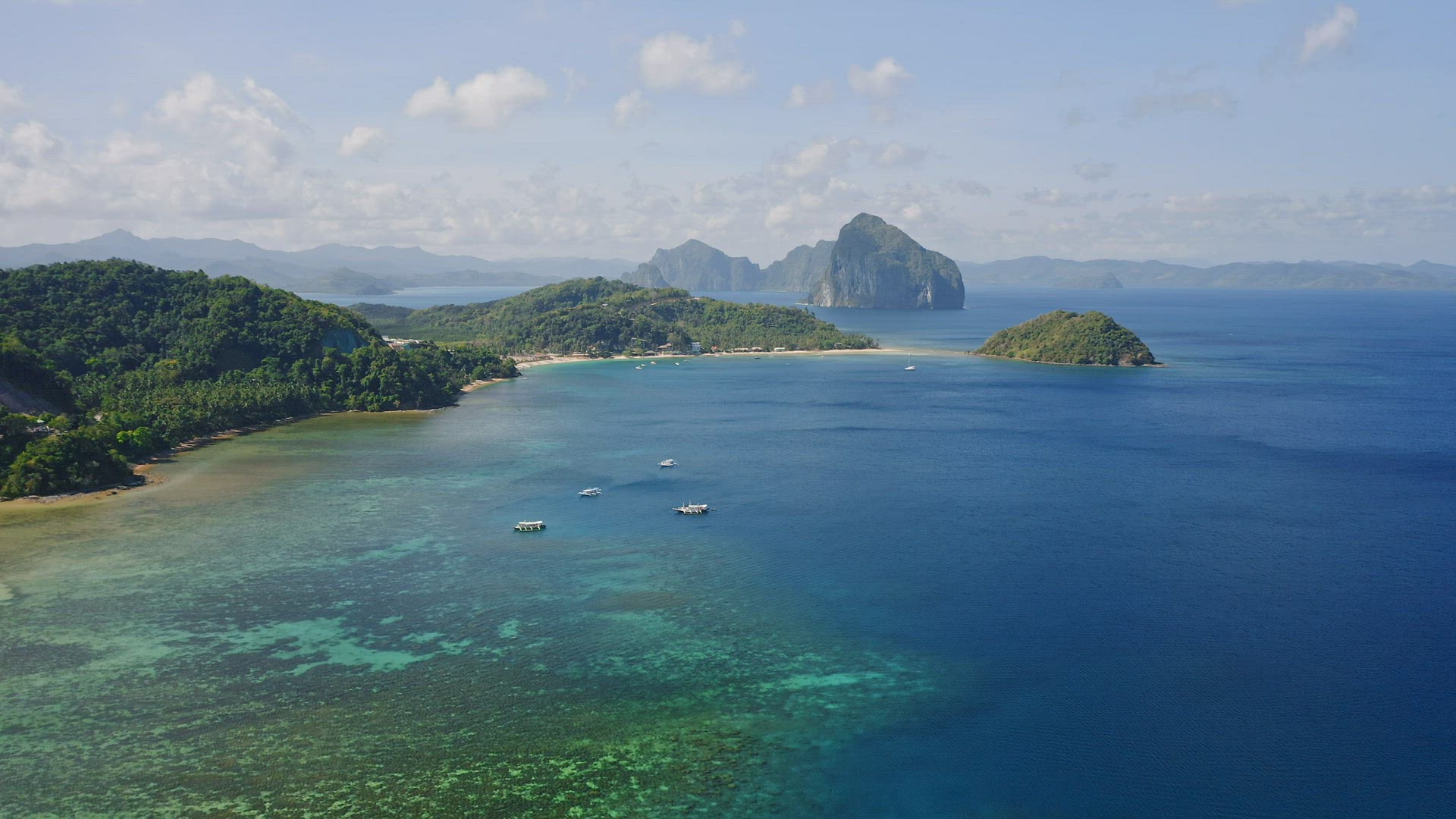 Aerial view of El Nido blue lagoon and tourist boats. Famous tourist place on the Palawan island. Se