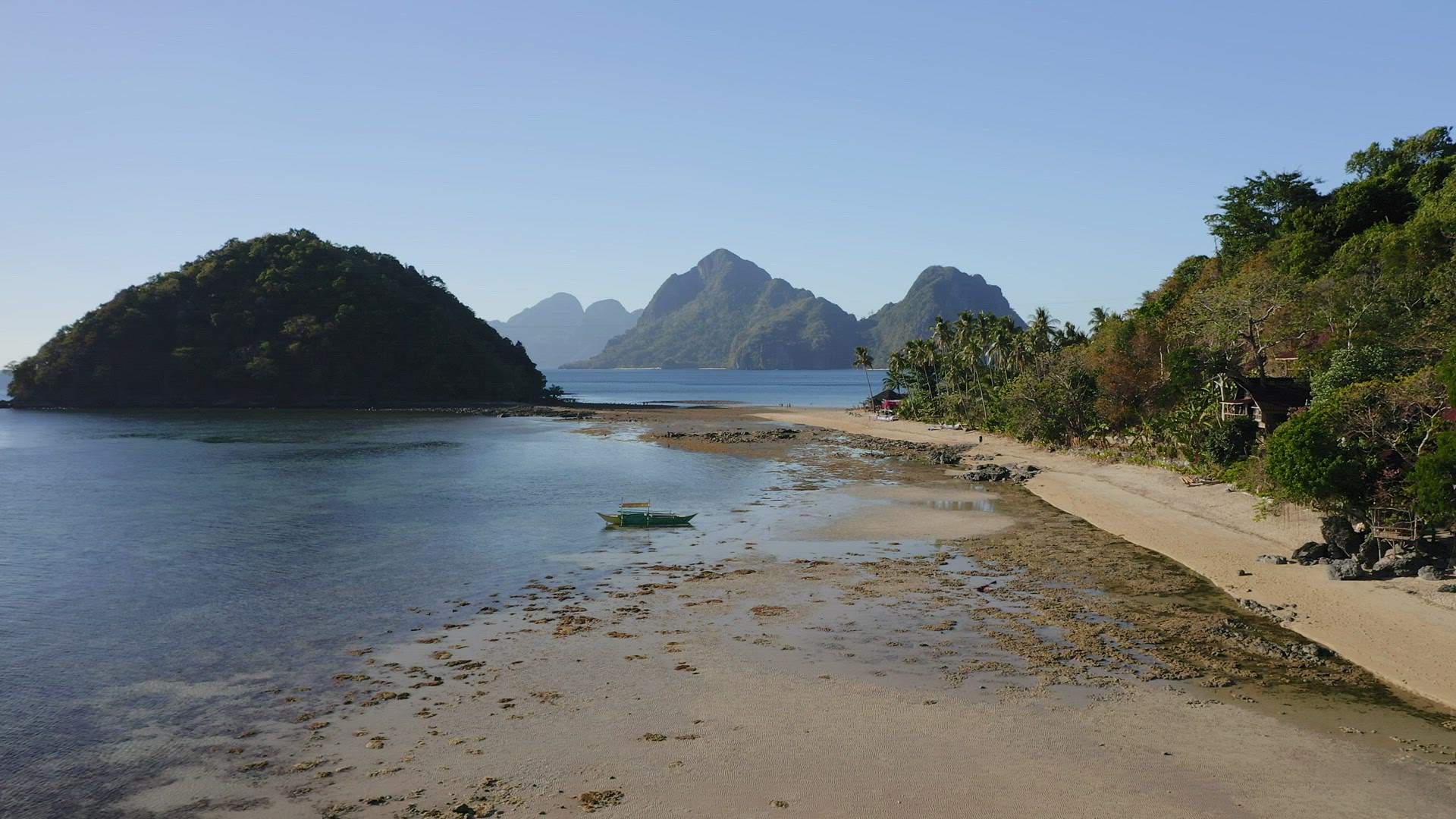 4k Aerial fly along the Cas Cabanas beach and Depeldet island on low tide, El Nido, Palawan, Philipp
