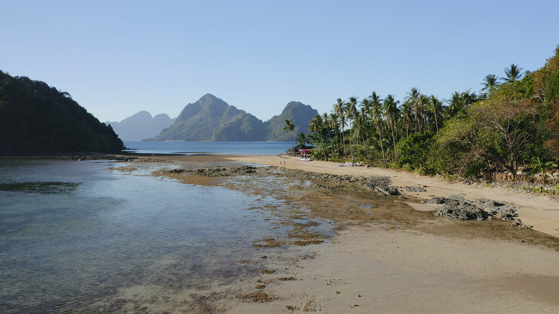 4k Aerial fly along the Cas Cabanas beach, El Nido, Palawan, Philippines. Tourists walking on tropic
