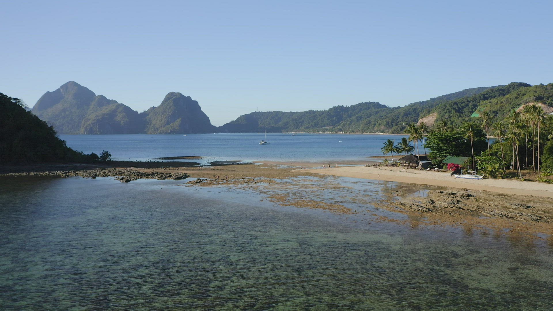 4k Aerial view of Cas Cabanas, El Nido, Palawan, Philippines. Tourists walking on tropical sandy bea
