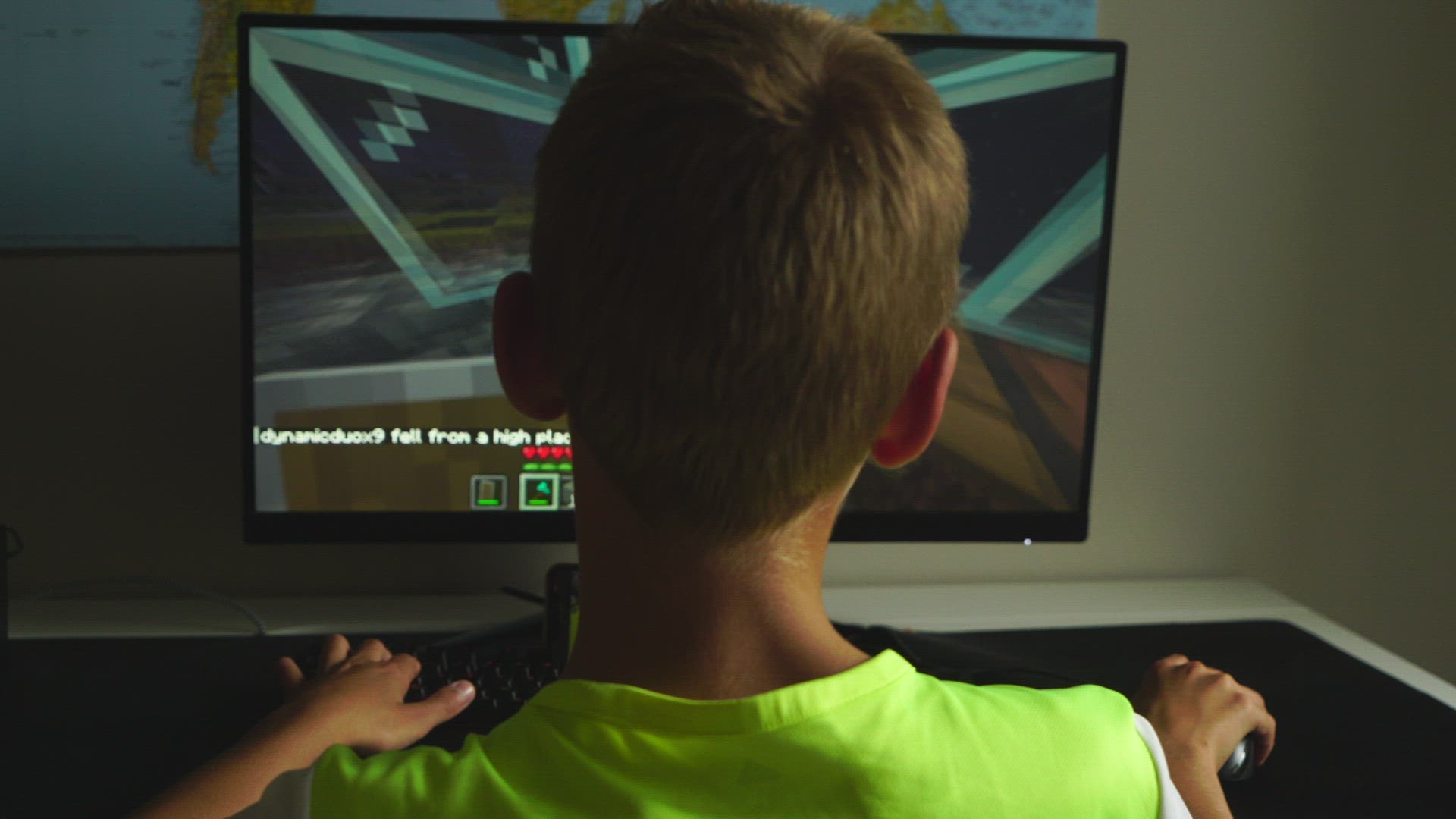 boy playing computer game - sitting in fron of computer screen